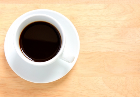 Black coffee in white cup on a wooden table の写真素材