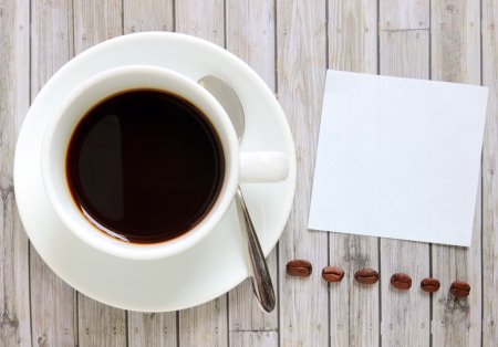 Blank paper with hot coffee cup and coffee beansの写真素材