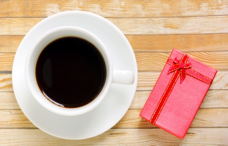 Cup of coffee with red present boxの写真素材