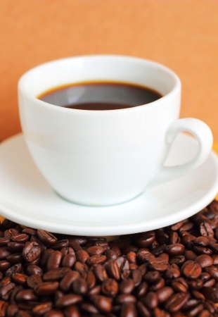 White cup of coffee on coffee beansの写真素材