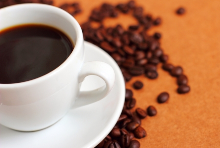 White cup of coffee on coffee beansの写真素材