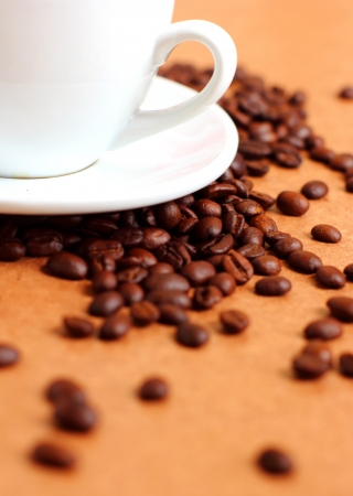 Part of white cup coffee with coffee beansの写真素材