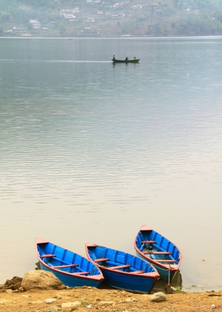 Boats on Phewa lake in Pokhara, Nepal の写真素材
