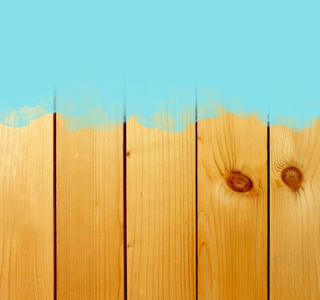 Blue stroke of the paint brush on wooden background の写真素材