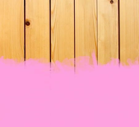 Pink stroke of the paint brush on wooden background の写真素材