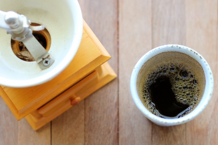 Black coffee with vintage coffee grinderの写真素材