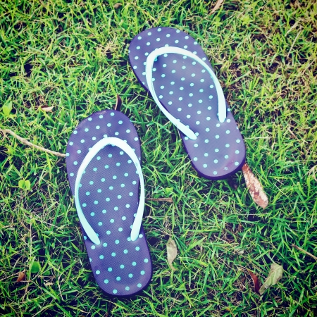 blue polka dot sandal on grass with retro filter effectの写真素材