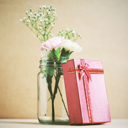 Flower with red present box, retro filter effectの写真素材