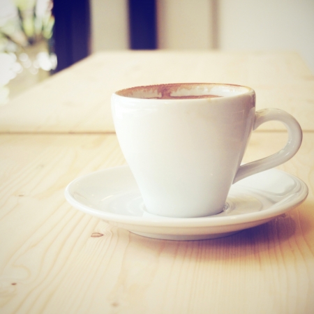 cup of coffee at coffee shop with retro filter effectの写真素材