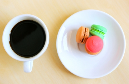 Colorful macaroons and a cup of coffeeの写真素材