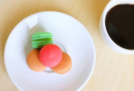 Colorful macaroons and a cup of coffeeの写真素材