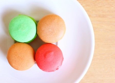 Tasty colorful macaroons on wooden backgroundの写真素材