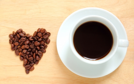 Cup of coffee with coffee beans heart shapeの素材