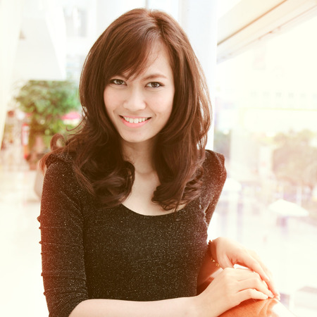 Portrait of young pretty asian woman smiling with retro filter effect の写真素材