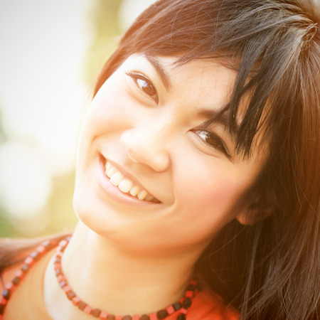 Close up of asian woman smiling with retro filter effectの写真素材
