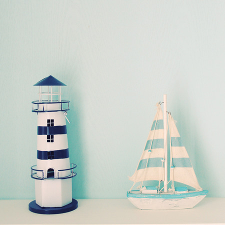 Lighthouse and ship model for decorated in room with retro filter effectの写真素材