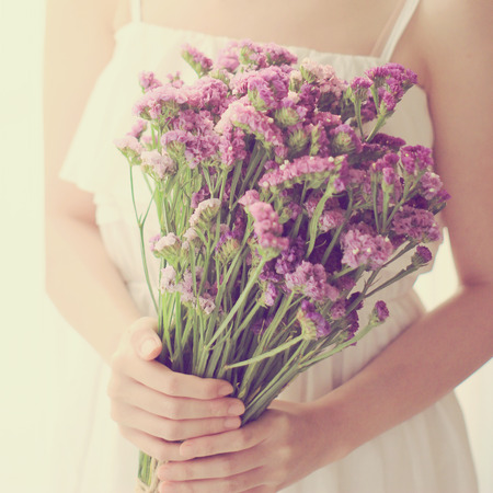 Bride or bridemaid with bouquet, closeup with retro filter effectの写真素材