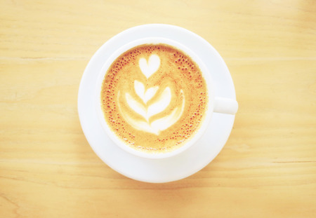 Cup of latte or cappuccino coffee with retro filter effect の写真素材