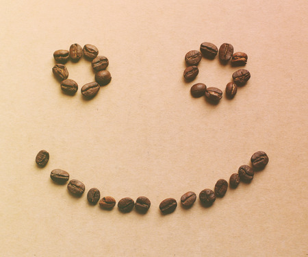 Happy face shaped of coffee beans with retro filter effect
