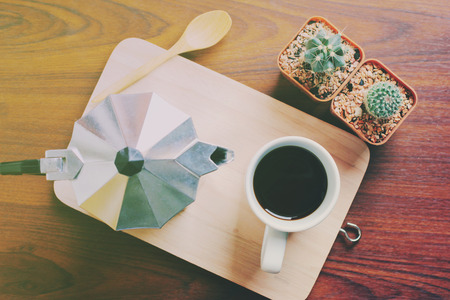 Hot coffee and moka pot with cactus, retro filter effectの写真素材