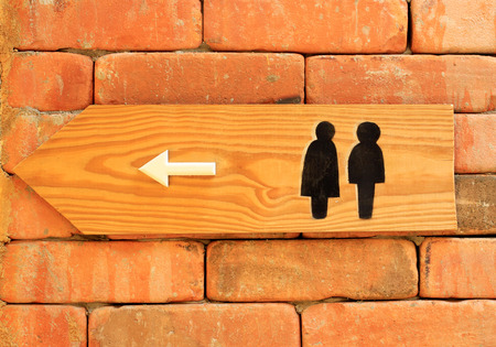 Toilet sign and direction on brick wallの写真素材