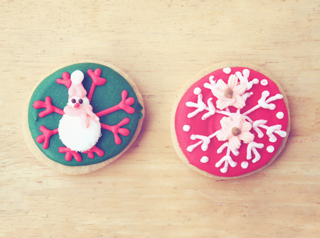 Decorated colorful gingerbread on wooden background with retro filter effectの写真素材