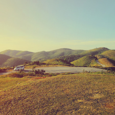 White car on the top of mountain with retro filter effect, travel conceptの写真素材