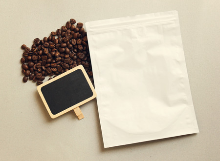 Bag of coffee and blank blackboard with coffee beans, retro filter effectの写真素材