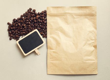 Bag of coffee and blank blackboard with coffee beans, retro filter effectの写真素材