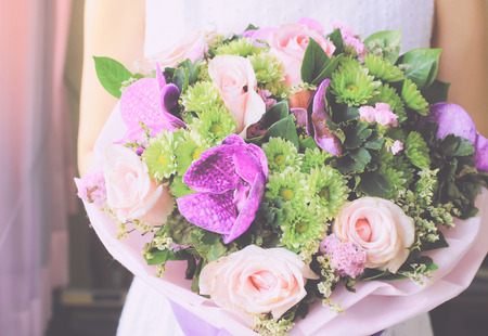 Bride or bridemaid with bouquet of flower, retro filter effectの写真素材