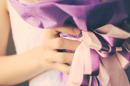 Bride or bridemaid with bouquet of flower, retro filter effectの写真素材