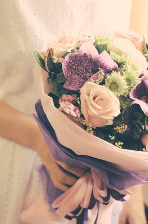 Bride or bridemaid with bouquet of flower, retro filter effectの写真素材