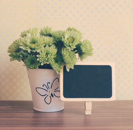 bunch of flower with blackboard, vintage filter styleの写真素材