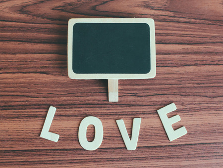 Blank blackboard with love alphabet wood, retro filter effectの写真素材