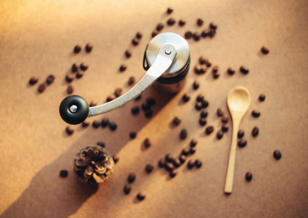 Coffee grinder and spoon with coffee beans, retro filter effectの写真素材