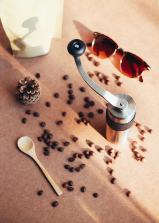 Coffee grinder and sunglasses with coffee beans, retro filter effectの写真素材