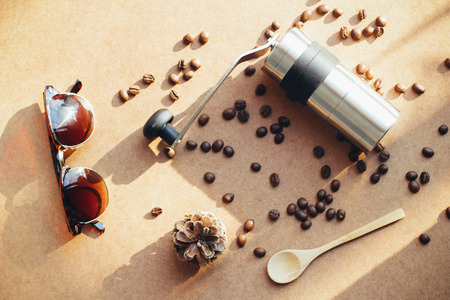 Coffee grinder and sunglasses with coffee beans, retro filter effectの写真素材