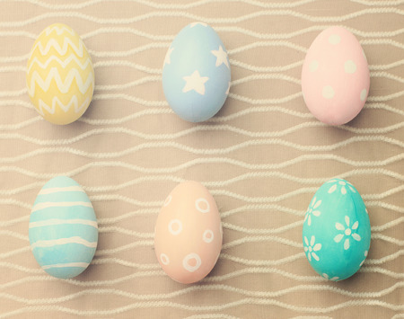 Top view of colorful easter eggs on cloth with retro filter effectの写真素材