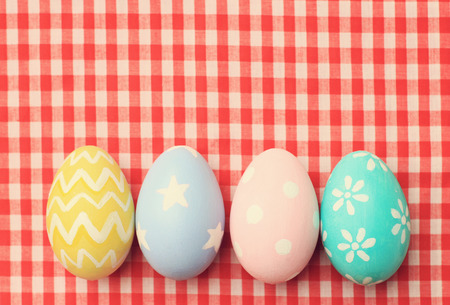 Colorful easter eggs on tablecloth with retro filter effectの写真素材
