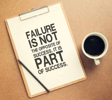 Inspirational motivating quote on clipboard and cup of coffee with retro filter effectの写真素材