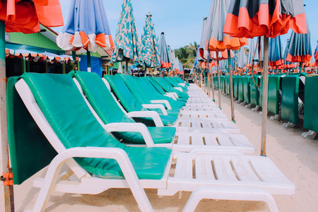 Row of chairs and umbrella on tropical  sand beachの写真素材