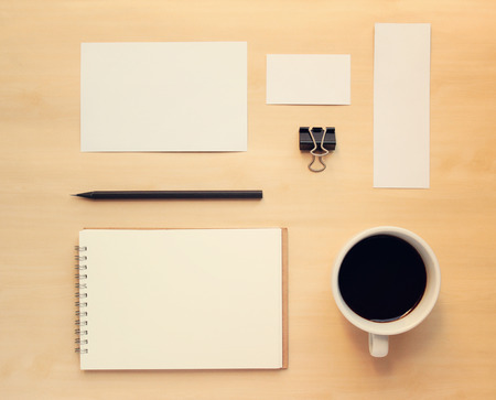 Business branding mock up set in workspace with retro filter effectの写真素材
