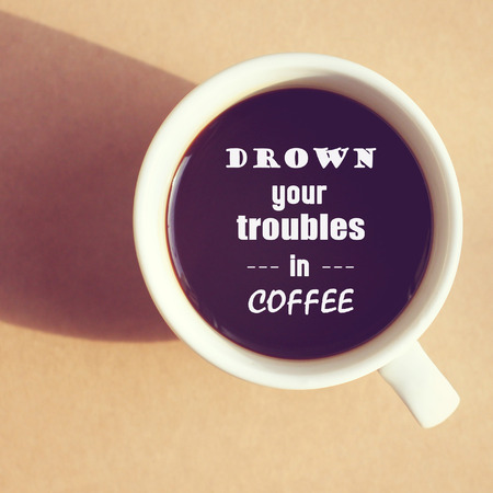 Inspirational quote on cup of coffee with retro filter effectの写真素材