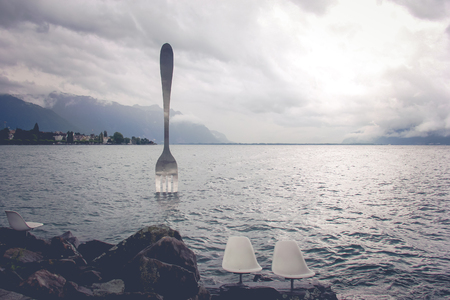 Vevey, Switzerland - AUGUST 13,2014: Giant steel fork in water of Geneva lake, Vevey, Switzerland.の写真素材