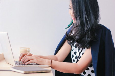 Beautiful successful asian woman using laptop in the cafe or officeの写真素材