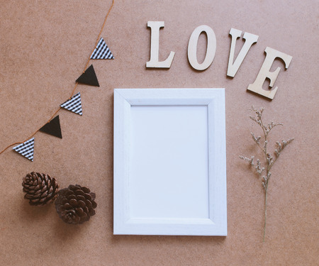 Photo frame mockup and craft decorated with love wooden alphabetの写真素材