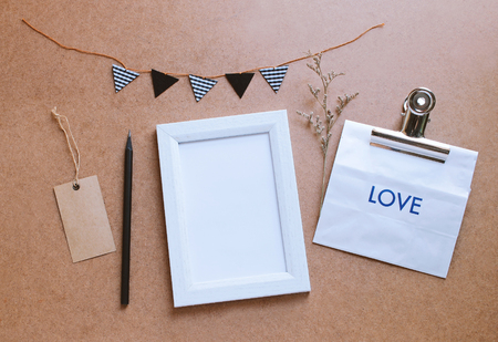 Photo frame mockup and cute craft decorated with paper bag giftの写真素材
