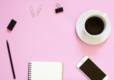 Creative header design mockup set of workspace desk with smartphone, coffee, stationery and notebook with copy space backgroundの写真素材