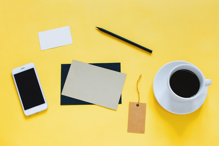 Creative flat lay photo of workspace desk with smartphone, coffee, tag and letter with copy space...