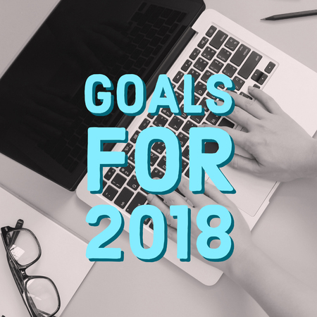 Inspirational quote word, goals for 2018 on hands using computer laptop, business conceptの写真素材